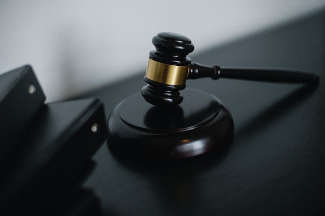 Black wooden gavel on a black table